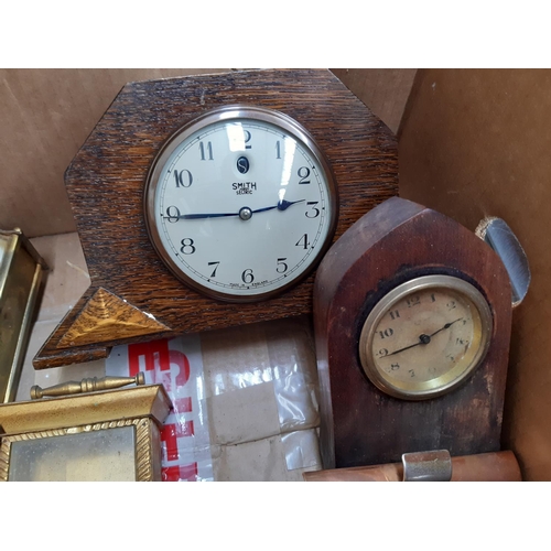 139 - A box containing a collection of various clocks to include a 1920s oak cased mantel clock with off w... 