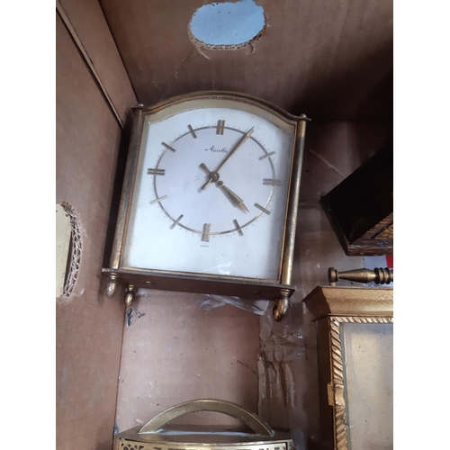 139 - A box containing a collection of various clocks to include a 1920s oak cased mantel clock with off w... 