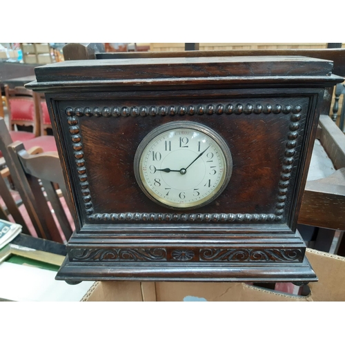 139 - A box containing a collection of various clocks to include a 1920s oak cased mantel clock with off w... 