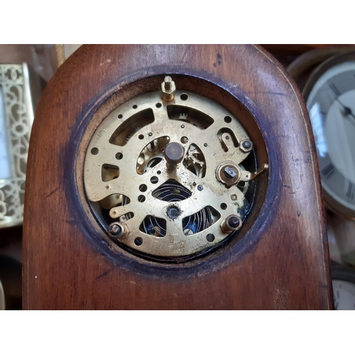 139 - A box containing a collection of various clocks to include a 1920s oak cased mantel clock with off w... 