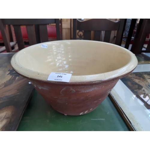 141 - A Victorian Welsh slip ware dairy bowl - measuring approx. 34cm in diameter