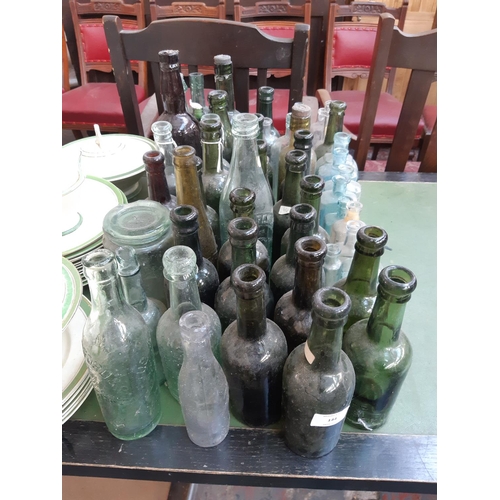 144 - A large collection of various vintage glass bottles to include ‘Dr Kilmer’s swamp root kidney, liver... 