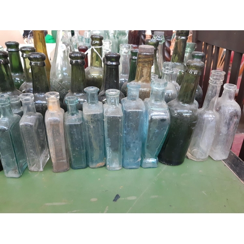 144 - A large collection of various vintage glass bottles to include ‘Dr Kilmer’s swamp root kidney, liver... 