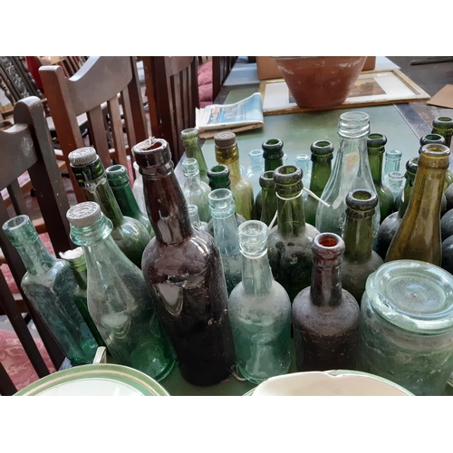 144 - A large collection of various vintage glass bottles to include ‘Dr Kilmer’s swamp root kidney, liver... 