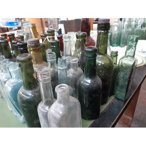 144 - A large collection of various vintage glass bottles to include ‘Dr Kilmer’s swamp root kidney, liver... 