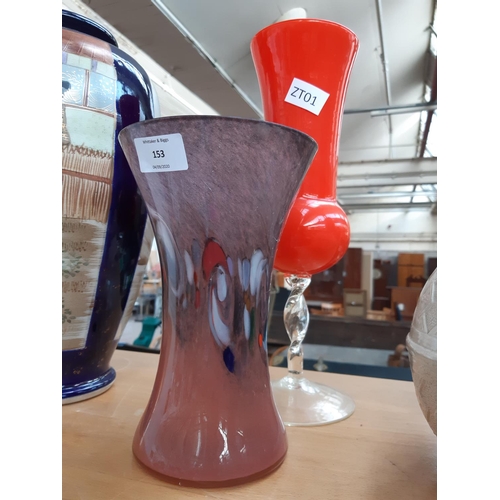 153 - Two art glass vases to include a retro orange vase supported on twisted clear glass base and a mottl... 