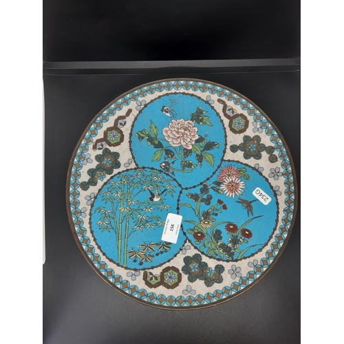 156 - A Japanese Meiji period plate with colourful cloisonné enamel, depicting stylised flowers, birds, ba... 