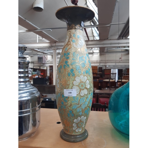 158 - A tall Doulton Lambeth vase with floral design with green, gold, blue and white tones, impressed mar... 