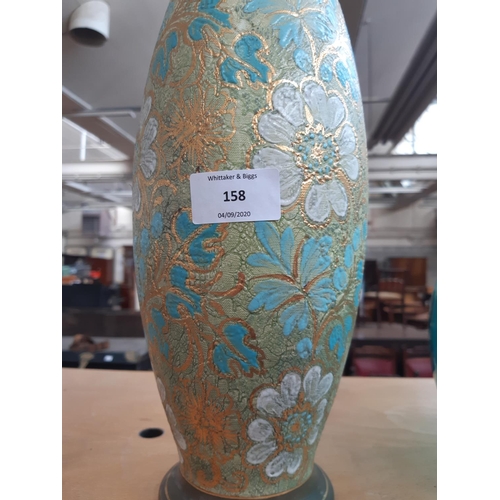 158 - A tall Doulton Lambeth vase with floral design with green, gold, blue and white tones, impressed mar... 