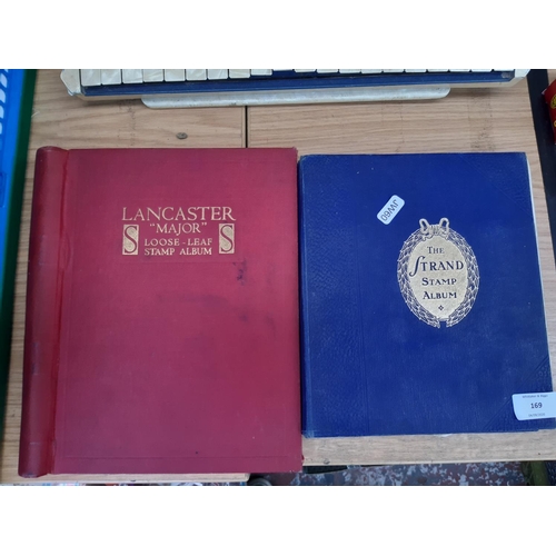 169 - Two stamp albums to include a red ‘Strand’ and a ‘Lancaster Major’, each containing a selection of w... 