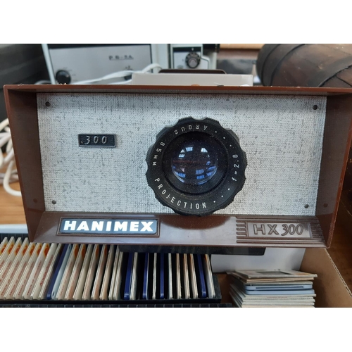 173 - A vintage Heurtier P6-24 projector, a Hanimex 300 projector and a large quantity of slides