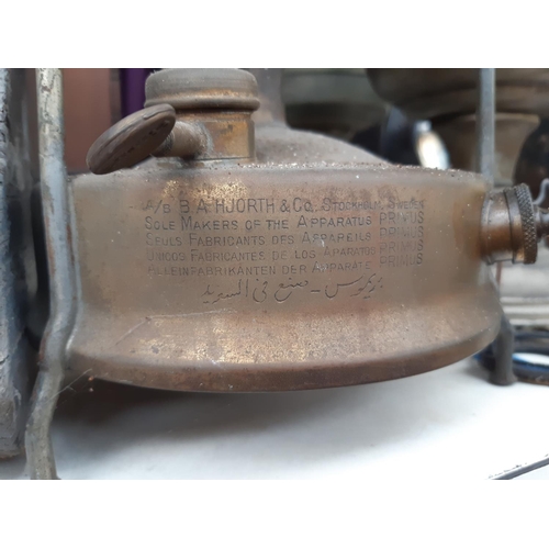 181 - Two vintage chromed oil lamps together with a brass Primus stove