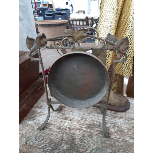 192 - Two vintage dinner gongs to include an Art Nouveau brass example with decorative leaf top and a late... 