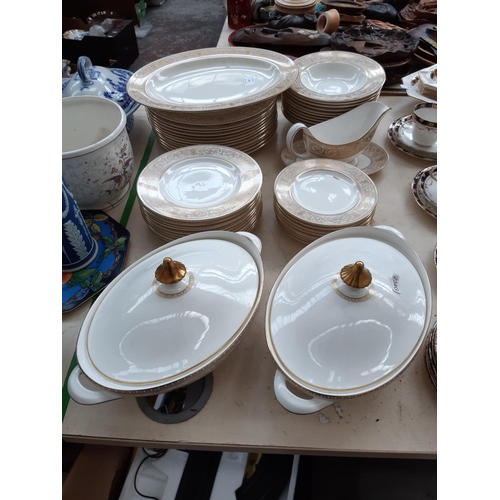 210 - A 53 piece Royal Doulton ‘Sovereign’ pattern part dinner service comprising two tureens, 12 side pla... 