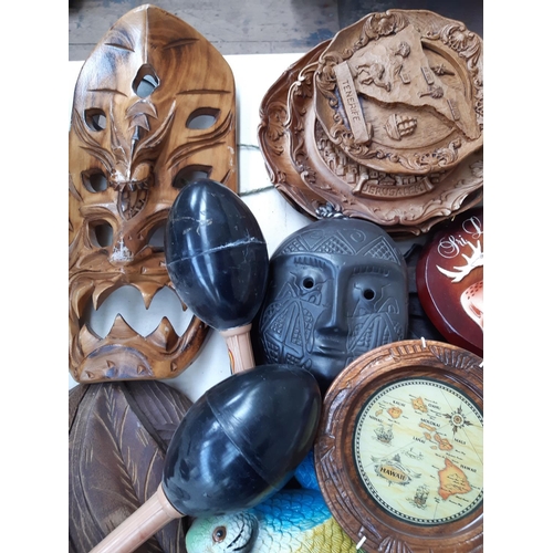 212 - A large collection of mostly treen ornaments to include decorative African tribal masks, dishes, pla... 