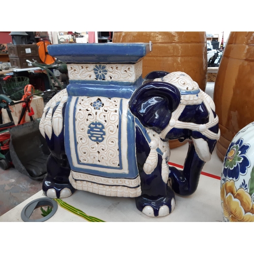 216 - Three items to include an oriental style ceramic blue and white elephant plant stand together with t... 