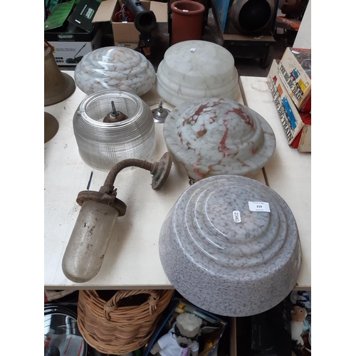 219 - Four Art Deco mottled glass fly catcher ceiling light shades together with a 1930s industrial glass ... 