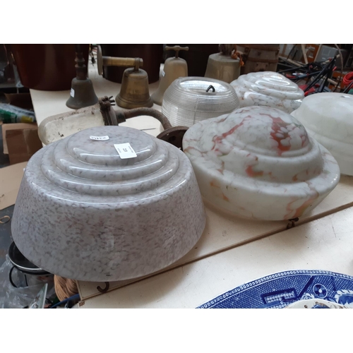 219 - Four Art Deco mottled glass fly catcher ceiling light shades together with a 1930s industrial glass ... 