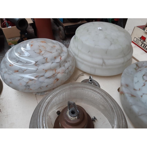 219 - Four Art Deco mottled glass fly catcher ceiling light shades together with a 1930s industrial glass ... 