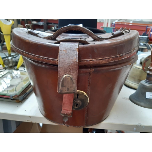 221 - A Victorian brown leather top hat travel case with red interior together with a vintage Moore’s of L... 