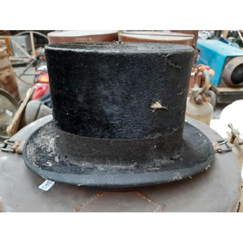 222 - A Victorian brown leather top hat case containing Battersby & co of London top hat together with an ... 