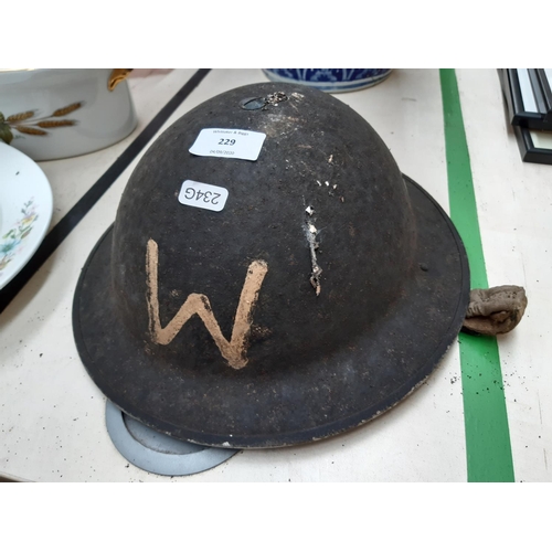 229 - A WWII British military Brodie helmet