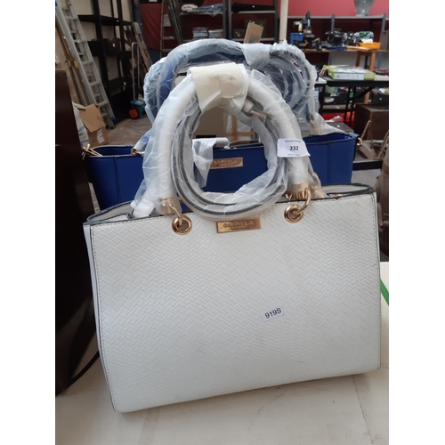 232 - Two as new Carmela Kurt Geiger hand bags to include one white and one dark blue