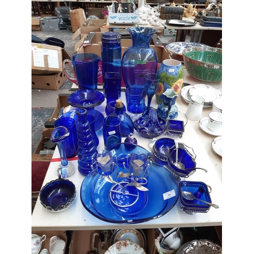 243 - A large collection of blue glassware to include vases, bowls, glasses etc.