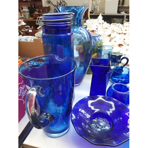 243 - A large collection of blue glassware to include vases, bowls, glasses etc.