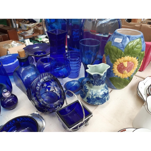 243 - A large collection of blue glassware to include vases, bowls, glasses etc.