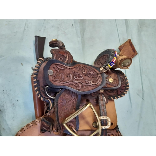 A Native American brown leather saddle bag with painted eagle design
