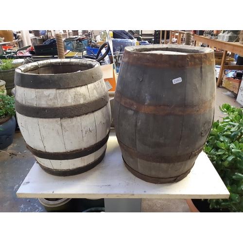 702 - Four items to include a wooden 'Pimlott's' sign, two vintage wooden barrels and a vintage wooden pre... 