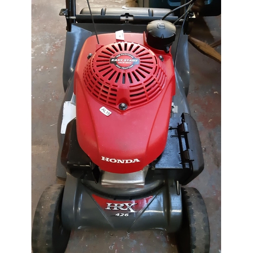 723 - A red and grey Honda HRX 426 petrol lawn mower with easy start engine