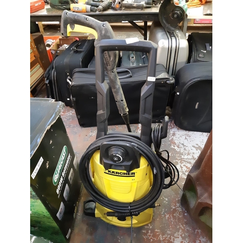 730 - A black and yellow Karcher K4 electric pressure washer with hose and lance (Shop return)