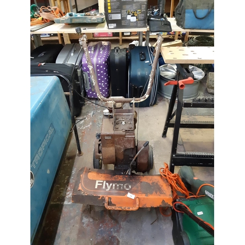 734 - A vintage orange Flymo petrol rotavator with 3HP Briggs & Stratton engine