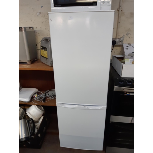 763 - A white upright fridge freezer - measuring approx. 143cm tall