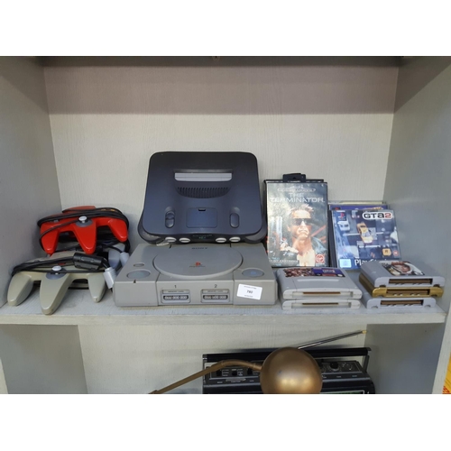 780 - A mixed lot of vintage gaming equipment to include Nintendo 64, Playstation 1, two Sega Mega Drives ... 