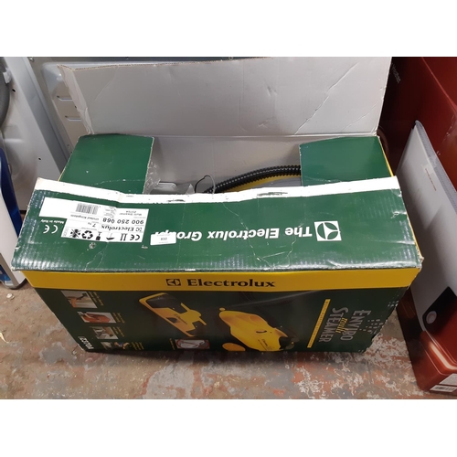 832 - A boxed yellow and grey Electrolux enviro steamer and fittings