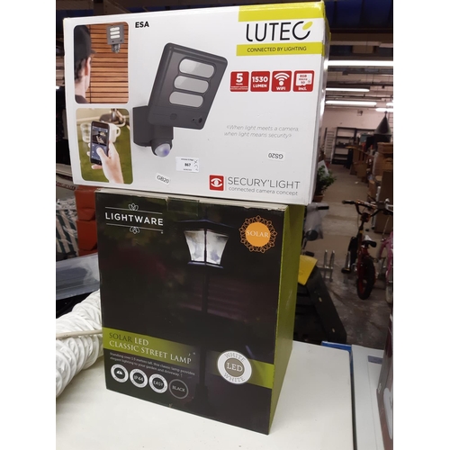 867 - Two boxed items to include a Lutec connected camera security light together with a Lightware solar L... 