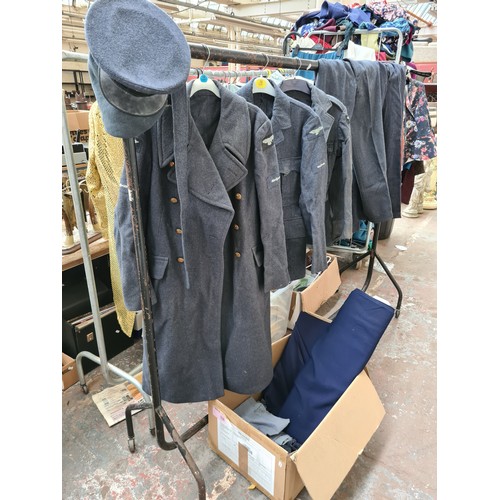 239 - A collection of 1950’s RAF uniform each bearing original arm patches to include a greatcoat dated 19... 