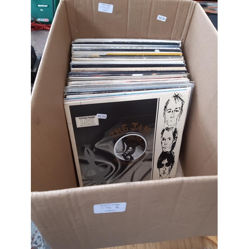 176A - A box containing various LP records to include The Jam, Pink Fairies, Sparks, Madness, Van Morrison,... 