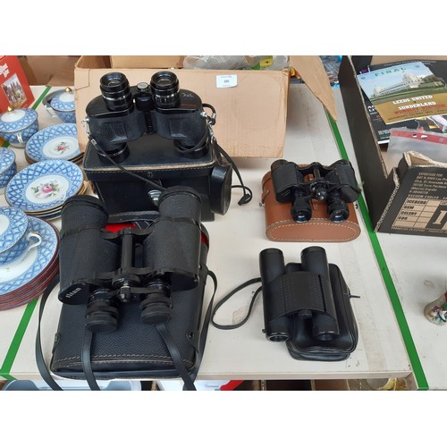 206 - Four pairs of vintage cased binoculars to include a pair of Hunter model 711 8x30, Titan 10 X 50, El... 