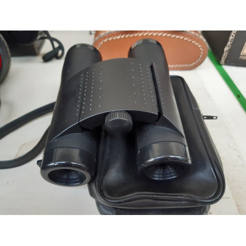 206 - Four pairs of vintage cased binoculars to include a pair of Hunter model 711 8x30, Titan 10 X 50, El... 