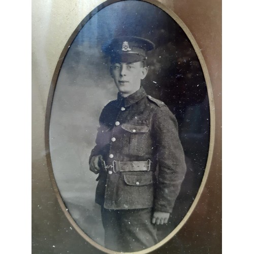 57 - A gilt framed WWI presentation medal set with two medals, one being a service medal and the other a ... 