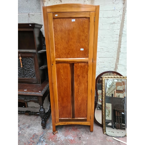 489 - A mid 20th century oak effect single door wardrobe - measuring approx. 67cm wide, 40cm deep and 183c... 