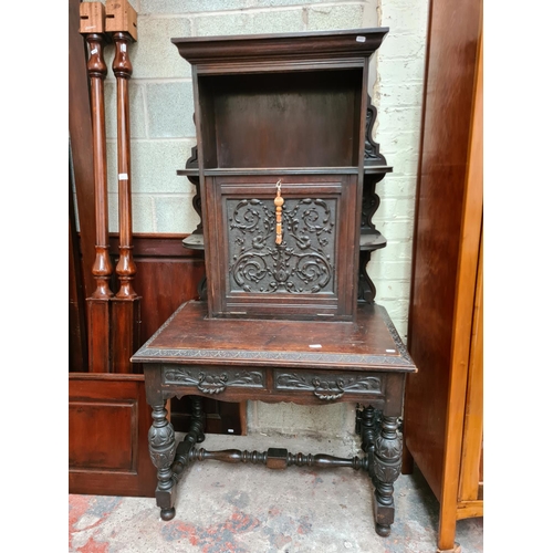 490 - A Victorian Jacobean revival oak bureau cabinet with fall front, key, two drawers and lower stretche... 