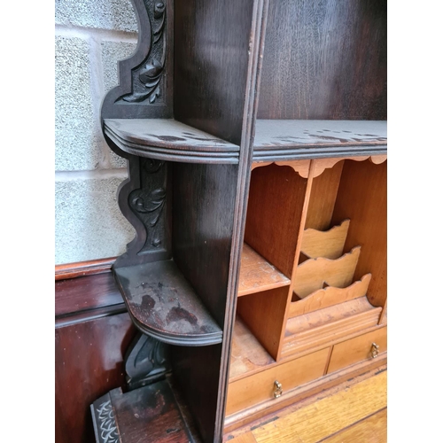 490 - A Victorian Jacobean revival oak bureau cabinet with fall front, key, two drawers and lower stretche... 