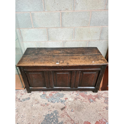 492 - An 18th century oak coffer - measuring approx. 61cm high, 124cm wide and 53cm deep