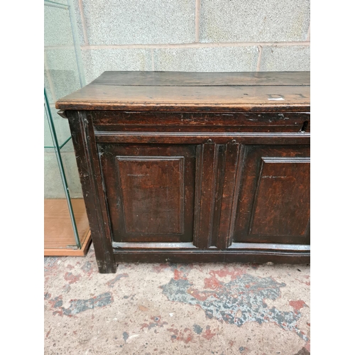 492 - An 18th century oak coffer - measuring approx. 61cm high, 124cm wide and 53cm deep