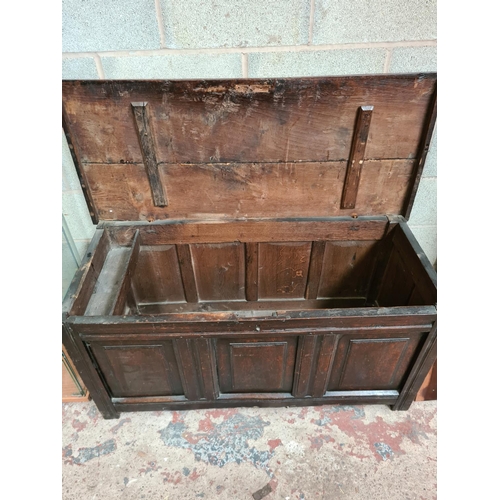 492 - An 18th century oak coffer - measuring approx. 61cm high, 124cm wide and 53cm deep